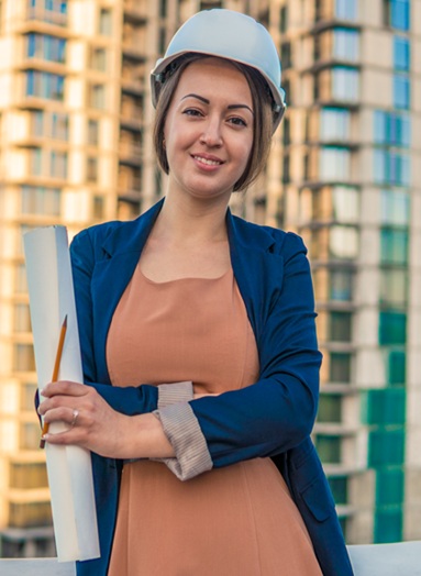 http://business%20woman%20engineer%20is%20standing%20with%20plan%20papers.%20Construction%20project%20is%20on%20background